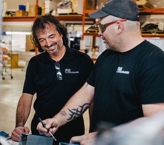 Two people collaborating in a manufacturing workshop.
