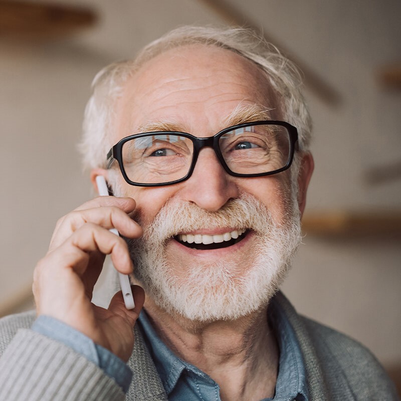 An old man talking on the phone